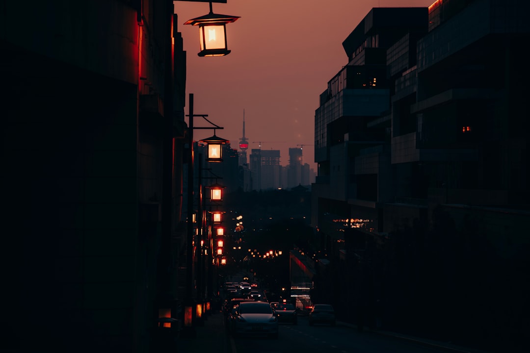 a-city-street-at-night-with-a-street-light-in-the-foreground-w22sbz6ulti