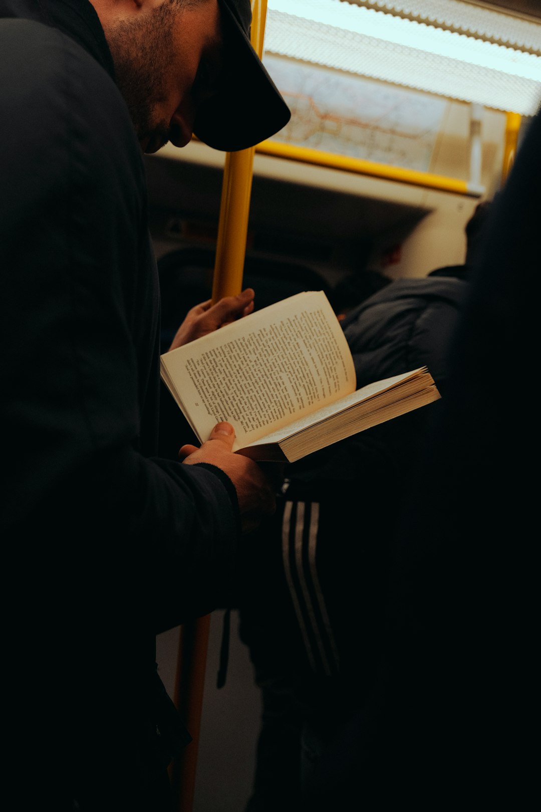 a-man-reading-a-book-on-a-train-il5cea6x9m